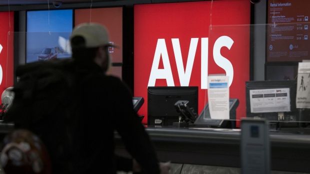 A customer waits at an Avis Budget Group Inc. rental counter at San Francisco International Airport in San Francisco, California, U.S., on Monday, May 4, 2020. Avis Budget Group's first-quarter loss widened and it said April and May revenue could decline 80% year-over-year.