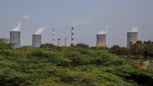Chimneys and cooling towers at the coal-fired NTPC Simhadri thermal power plant in the outskirts of Visakhapatnam, Andhra Pradesh, India, on Sunday, March 20, 2022. India, the world’s third biggest emitter of greenhouse gases, plans to more than triple its clean-energy capacity by the end of the decade and zero out emissions by 2070. Photographer: Dhiraj Singh/Bloomberg