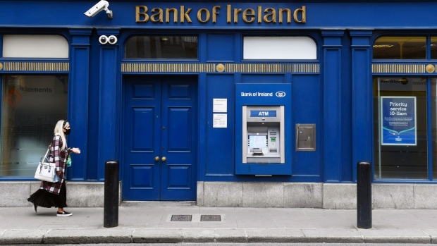 A pedestrian wearing a protective face mask passes a Bank of Ireland Plc bank branch in Dublin, Ireland, on Monday, Aug. 10, 2020. Ireland is one of the most open countries in the world in economic terms, according to the KOF Globalisation Index, having built its economic strategy on a low corporate tax rate and a plentiful supply of well-educated, English-speaking workers.