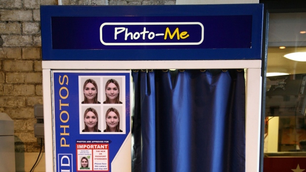 A woman uses a Photo-Me photo booth in Victoria Station, London, U.K., on Thursday, Nov. 29, 2007. Photo-Me International Plc, the U.K. operator of 25,000 photo booths, fell the most in 16 years in London trading after saying full-year results will be ``substantially'' below analysts' estimates. Photographer: FRANTZESCO KANGARIS/Bloomberg