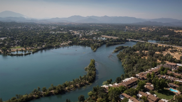 REDDING, CA - AUGUST 4: The Sacramento River flows through the downtown area as viewed on a smoky afternoon on August 4, 2021, near Redding, California. Redding, a former logging town in the shadow of Mt. Shasta, is the economic and cultural capital of the Shasta Cascade region of Northern California and the county seat of Shasta County. (Photo by George Rose/Getty Images)