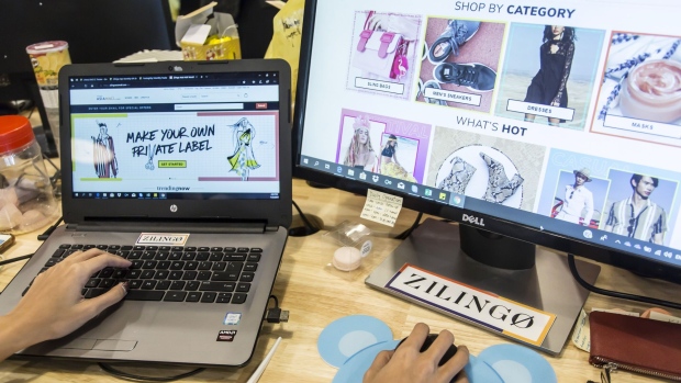 An employee works in front of computers at the Zilingo Pte office in Singapore, on Monday, Feb.. 11, 2019. Zilingo said it raised $226 million from investors including Sequoia Capital and Temasek Holdings Pte. The latest financing valued the fashion platform at $970 million, according to people familiar with the matter, who asked not to be named because the information is private. That makes 27-year-old co-founder and chief executive officer Ankiti Bose among the youngest female chief executives to lead a startup of the size in Asia.