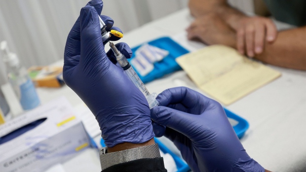 A healthcare worker prepares to administer a vaccine to a person for the prevention of monkeypox in Wilton Manors, Florida on July 12.