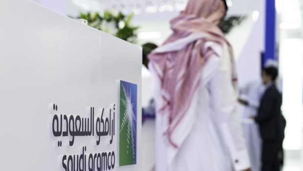 A Saudi Aramco logo sits on display during the Abu Dhabi International Petroleum Exhibition & Conference (ADIPEC) in Abu Dhabi, United Arab Emirates, on Tuesday, Nov. 13, 2018. OPEC’s secretary-general, energy ministers from Saudi Arabia to Russia, CEOs at oil majors from Total SA, BP Plc and Eni SpA, and officials from Middle Eastern energy giants such as Abu Dhabi’s Adnoc have gathered to sign deals and discuss oil, gas, refining and petrochemical issues. Photographer: Christopher Pike/Bloomberg