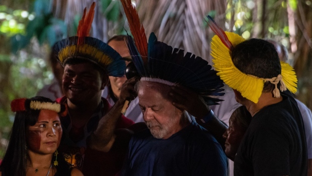 Luiz Inacio Lula da Silva, Brazil's former president, second right, greets attendees during an event with the indigenous community at Parque dos Igarapes in Belem, Para state, Brazil, on Friday, Sept. 2, 2022. A fresh round of Brazil polls show that President Jair Bolsonaro's cash subsidies for the poor, a flood of campaign ads and a bad-tempered debate failed to sway voters weeks before general elections as leftist challenger Lula maintained a large lead.