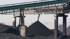 A conveyor bridge over piles of coal at the Mafube open-cast coal mine, operated by Exxaro Resources Ltd. and Thungela Resources Ltd., in Mpumalanga, South Africa on Friday, Sept. 9, 2022. South Africa relies on coal to generate more than 80% of its electricity, and has been subjected to intermittent outages since 2008 because state utility Eskom Holdings SOC Ltd. can't meet demand from its old and poorly maintained plants. Photographer: Waldo Swiegers/Bloomberg