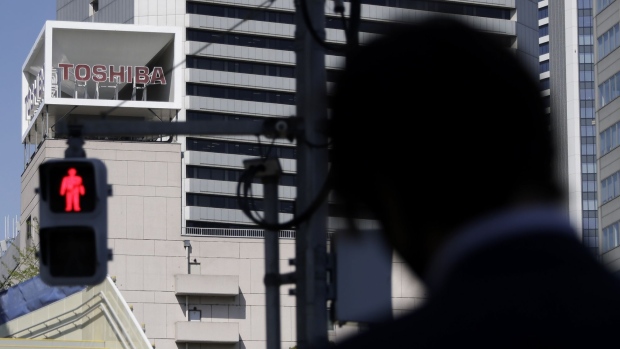 Signage for Toshiba Corp. displayed at the company's headquarters in Tokyo, Japan, on Wednesday, April 7, 2021. Toshiba surged its daily limit of 18% after confirming it received an initial buyout offer from CVC Capital Partners, setting the stage for potentially the largest private equity-led acquisition in years.