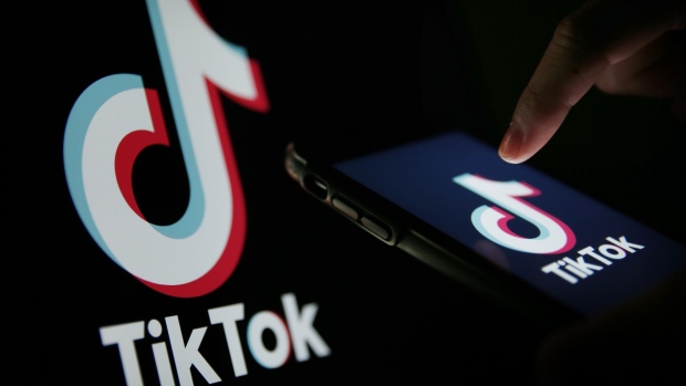The TikTok logo is displayed on a smartphone in this arranged photograph in London, U.K., on Monday, Aug. 3, 2020. TikTok has become a flash point among rising U.S.-China tensions in recent months as U.S. politicians raised concerns that parent company ByteDance Ltd. could be compelled to hand over American users’ data to Beijing or use the app to influence the 165 million Americans, and more than 2 billion users globally, who have downloaded it. Photographer: Hollie Adams/Bloomberg