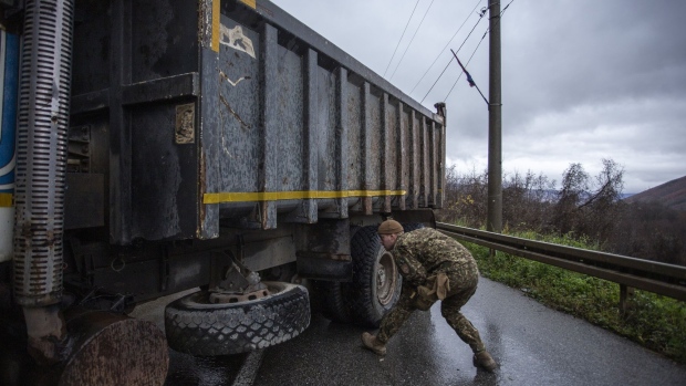 ZUBIN POTOK, KOSOVO - DECEMBER 11: A NATO led Latvian soldier inspects a truck at a roadblock on one of the main roads to the border crossing point with Serbia on December 11, 2022 near Zubin Potok, Kosovo. (Photo by Ferdi Limani/Getty Images)