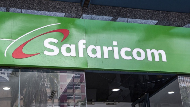 A logo above the entrance to a Safaricom Plc store in central Nairobi, Kenya. Photographer: Patrick Meinhardt/Bloomberg