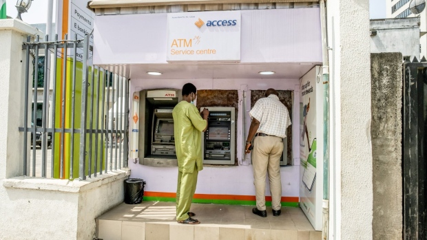 Customers use automatic teller machines (ATM) outside an Access Bank Plc bank branch in Lagos, Nigeria, on Friday, April 22, 2022. Choked supply chains, partly due to Russia’s invasion of Ukraine, and an almost 100% increase in gasoline prices this year, are placing upward price pressures on Africa’s largest economy. Photographer: Damilola Onafuwa/Bloomberg