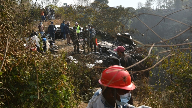Rescuers at the site of a Yeti Airlines plane crash in Pokhara on Jan. 15. Photographer: Prakash Mathema/AFP/Getty Images