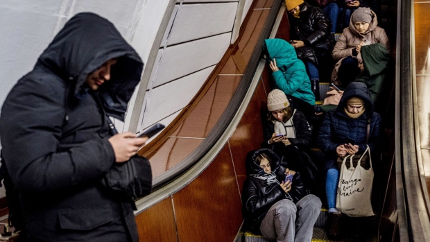People shelter in a metro station during an air strike alarm in Kyiv on Feb. 10. Photographer: Dimitar Dilkoff/AFP/Getty Images