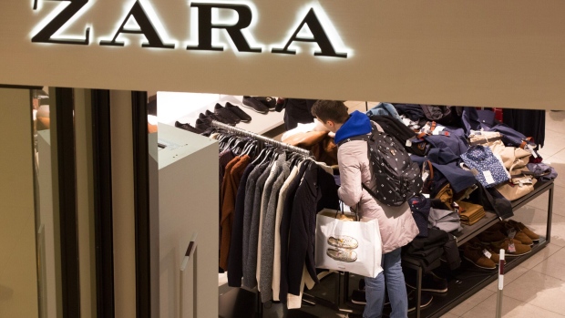 A customer browses a clothes rail inside a Zara fashion store, operated by Industria de Diseno Textil SA, during Black Friday sales at the Vegas shopping mall in Moscow, Russia, on Friday, Nov. 24, 2017. For most of the last decade, Russia's Central Bank Governor Elvira Nabiullina says Russians will get to enjoy some lower prices in time for New Year’s Eve parties, but her countrymen aren’t buying it.