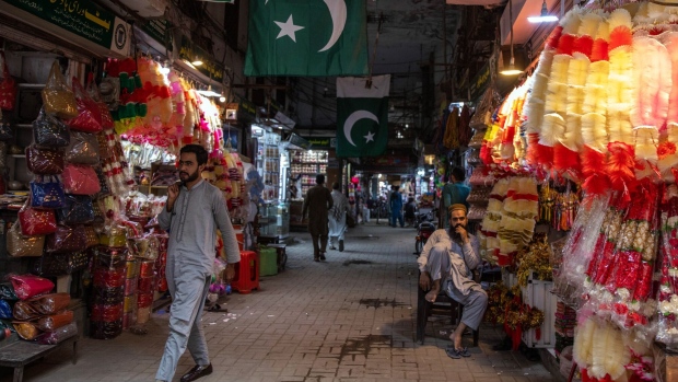 Shoppers pass street stalls in Lahore, Pakistan, on Thursday, June 1, 2023. Pakistan's inflation has hit another record high, making it Asia's fastest for a second month, just days before the national budget is due to be unveiled by a government facing unprecedented economic challenges.