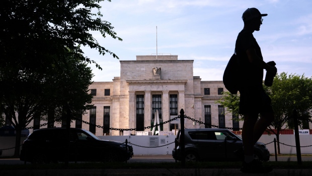 A pedestrian passes the Marriner S. Eccles Federal Reserve building in Washington, DC, US, on Saturday, June 3, 2023. Signs of labor-market slackening in May despite a pickup in hiring are likely to keep the Federal Reserve on hold this month while policymakers mull a hike later in the summer.