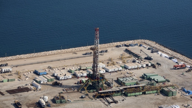 An oil drilling rig operates on an artificial causeway island in shallow waters at the Manifa offshore oilfield, operated by Saudi Aramco, in Manifa, Saudi Arabia, on Wednesday, Oct. 3, 2018. Saudi Arabia is seeking to transform its crude-dependent economy by developing new industries, and is pushing into petrochemicals as a way to earn more from its energy deposits.