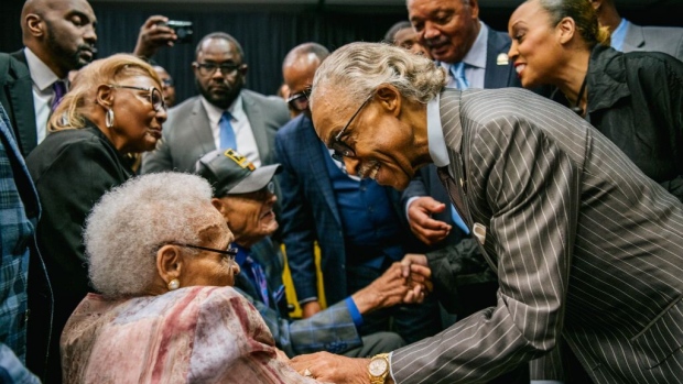 TULSA, OKLAHOMA - JUNE 01: Survivors Hughes Van Ellis and Viola Fletcher are greeted by Rev. Al Sharpton, and Rev. Jesse Jackson at a rally during commemorations of the 100th anniversary of the Tulsa Race Massacre on June 01, 2021 in Tulsa, Oklahoma. President Biden stopped in Tulsa to commemorate the centennial of the Tulsa Race Massacre. May 31st of this year marks the centennial of when a white mob started looting, burning and murdering in Tulsa's Greenwood neighborhood, then known as Black Wall Street, killing up to 300 people and displacing thousands more. Organizations and communities around Tulsa continue to honor and commemorate survivors and community residents. (Photo by Brandon Bell/Getty Images)