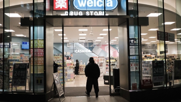 A customer enters a drug store operated by Welcia Holdings Co. at night in the Shinjuku district of Tokyo, Japan, on Saturday, April 4, 2020. With Prime Minister Shinzo Abe’s government stuck on the brink of declaring a state of emergency that might lead to a lockdown, Japan’s restaurant, bar and chain stores are taking matters into their own hands by voluntarily shuttering hundreds of stores to help curb the spread of the coronavirus.