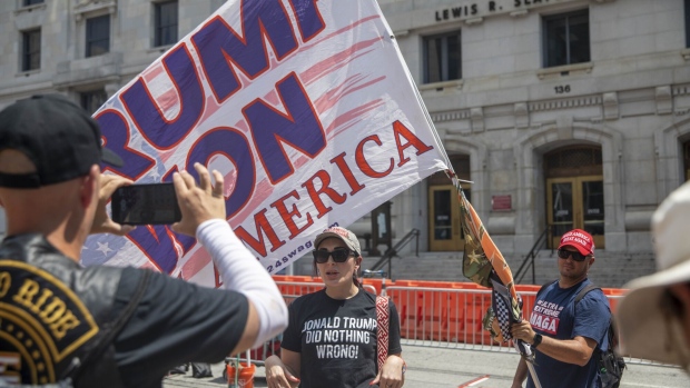 Supporters of former President Donald Trump rally outside of the Fulton County Courthouse in Atlanta, Georgia, US, on Friday. Aug. 25, 2023. Donald Trump turned himself in at the Fulton County Jail in Atlanta to be booked on state charges that he conspired to overturn the result of the 2020 presidential election in Georgia, the fourth time he's been processed as a criminal defendant this year.