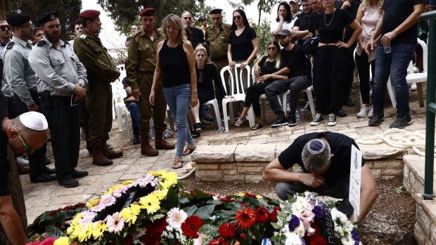 Family and friends attend the funeral of Afik Rozental, an Israeli soldier killed during fighting with Gaza militants, in Kfar Menahem, Israel, on Monday, Oct. 9. 2023.