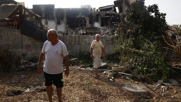 Local residents look at the damage to a police station destroyed by Palestinian militants in Sderot, Israel, on Sunday, Oct. 8, 2023. Fighting continued in southern Israel for a second day as Israeli Defence Forces sought to regain control of areas infiltrated yesterday by militants from the Gaza Strip. Photographer: Kobi Wolf/Bloomberg
