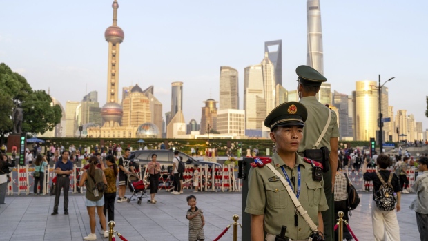 Paramilitary police officers stand guard near the Bund in Pudong's Lujiazui Financial District in Shanghai, China, on Monday, Sept. 18, 2023. China's central bank will strengthen efforts to stabilize trade and improve the business environment for foreign firms, its governor said Monday, adding to pledges among top leaders this year to open up to overseas investors. Photographer: Raul Ariano/Bloomberg