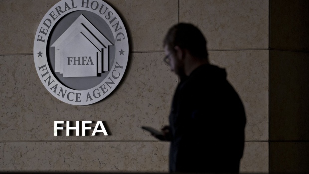 A pedestrian passes the seal of the Federal Housing Finance Agency (FHFA) outside the organization's headquarters in Washington, D.C., U.S., on Wednesday, March 20, 2019. President Donald Trump's pick to lead Fannie Mae and Freddie Macs regulator pledged to work with Congress on overhauling the companies, while downplaying controversial positions he's previously laid out on everything from the 30-year-mortgage to affordable housing initiatives. Photographer: Andrew Harrer/Bloomberg
