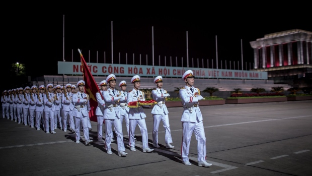 Soldiers march during a flag lowering ceremony at Ba Dinh Square at night in Hanoi, Vietnam, on Saturday, Feb. 16, 2019. Vietnam has been building military ties with the U.S. to balance a rising China and is among four dozen countries with a North Korean embassy. Photographer: Yen Duong/Bloomberg