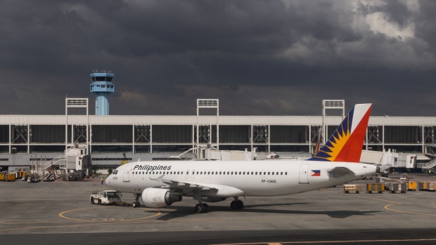 An Airbus SE A320-214 aircraft, operated by Philippine Airlines Inc., on the tarmac at the Ninoy Aquino International Airport (NAIA) in Manila, the Philippines, on Friday, Dec. 16, 2022. Shares of Philippine tourism and leisure-related companies are in focus after local media reported that domestic and international passengers surged in the first nine months of 2022, supporting the outlook that travel demand is gaining momentum. Photographer: SeongJoon Cho/Bloomberg