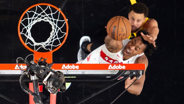Toronto Raptors forward Scottie Barnes puts up a shot over Golden State Warriors guard Stephen Curry