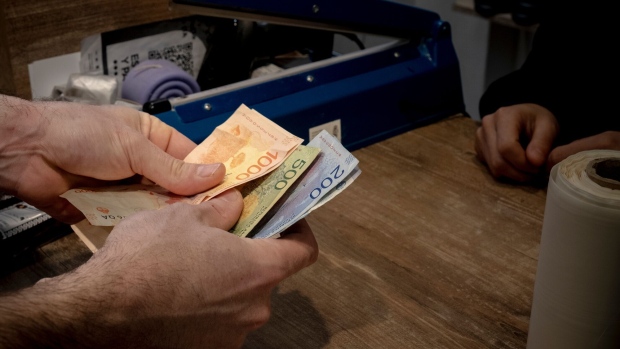 A customer pays with Argentine pesos in a shop in Buenos Aires, Argentina.