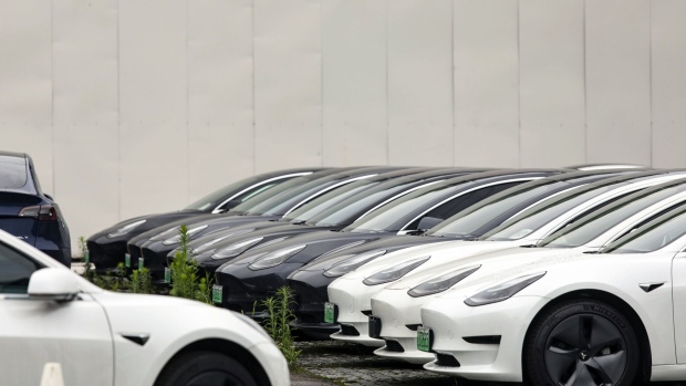 Tesla Model 3 EVs in a parking lot near one of the automaker's dealership in Shanghai. Photographer: Qilai Shen/Bloomberg