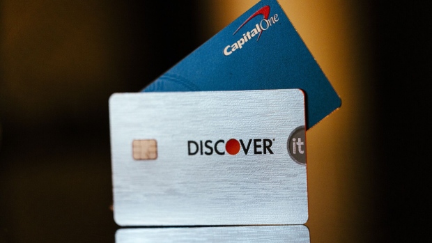 Capital One and Discover credit cards arranged in Germantown, New York, US, on Tuesday, Feb. 20, 2024. Capital One Financial Corp. agreed to buy Discover Financial Services in a $35 billion all-stock deal to create the largest US credit card company by loan volume, giving the combined entity a stronger foothold to compete with Wall Streets behemoths.