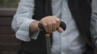 A man holds a cane in Sydney, Australia