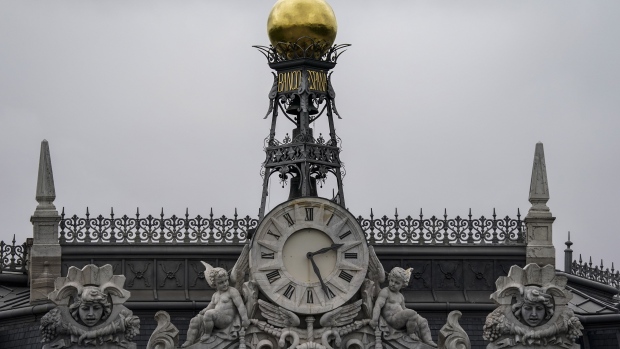 A gold finial stands above a clock at the headquarters of Spain's central bank, also known as Banco de Espana, in Madrid, Spain, on Tuesday, April 21, 2020. The coronavirus outbreak wont alter Bankia SA's plans to reduce its stock of soured loans in 2020. Photographer: Paul Hanna/Bloomberg