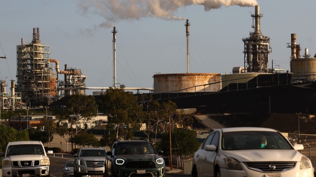 <p>Vehicles pass tan oil refinery in Wilmington, California. </p>