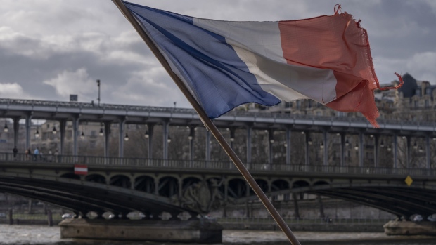 A French national flag flies from a tourist boat on the River Seine, in central Paris, France, on Wednesday, Feb. 14, 2024. Olympic organizers began working with Paris officials three years ago to clean the Seine, a venue for Paris 2024 Olympic swimming events. Photographer: Nathan Laine/Bloomberg