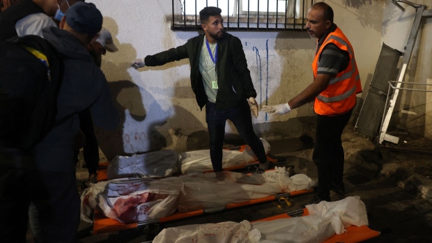 Medics prepare the bodies of Gazans killed in an Israeli strike on a camp for internally displaced Palestinians in Rafah on May 26. Photographer: Eyad Baba/AFP/Getty Images