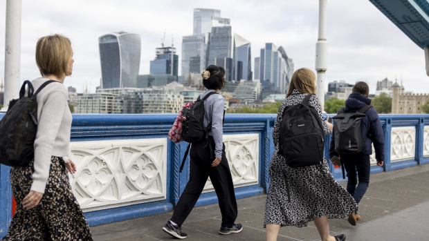 Commuters cross Tower Bridge in view of skyscrapers in the City of London square mile financial district in London, UK, on Monday, May 13, 2024. British economists worried about the accuracy of official labour market data have a new concern: doubts about the number of unfilled jobs. Photographer: Jason Alden/Bloomberg