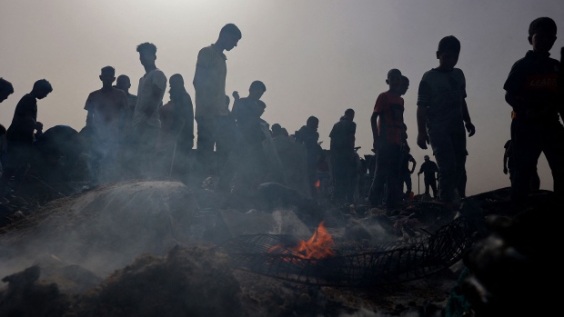 Palestinians gather at the site of an Israeli strike on a camp for internally displaced people in Rafah on May 27. Photographer: Eyad Baba/AFP/Getty Images