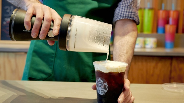 <p>A barista uses a portable blender to make cold foam at a Starbucks location in New York.</p>