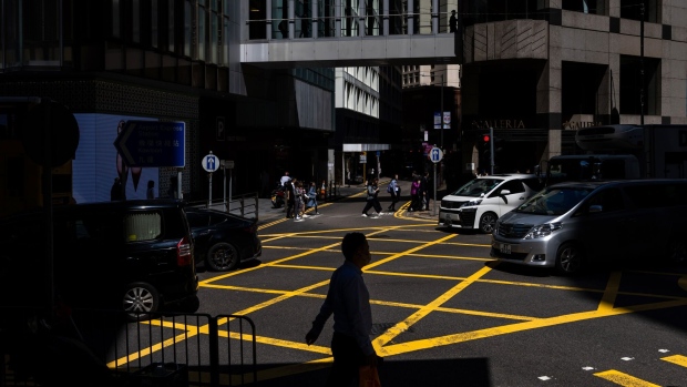 Pedestrians in the Central district in Hong Kong, China, on Tuesday, March 12, 2024. Hong Kong had more than 2,700 single-family offices based in the city last year, following the government's push to bolster its status as an Asian wealth hub. Photographer: Paul Yeung/Bloomberg