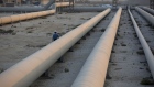Transport pipes leading to oil storage tanks at the Juaymah tank farm at Saudi Aramco's Ras Tanura oil refinery and oil terminal in Ras Tanura, Saudi Arabia. Photographer: Simon Dawson/Bloomberg