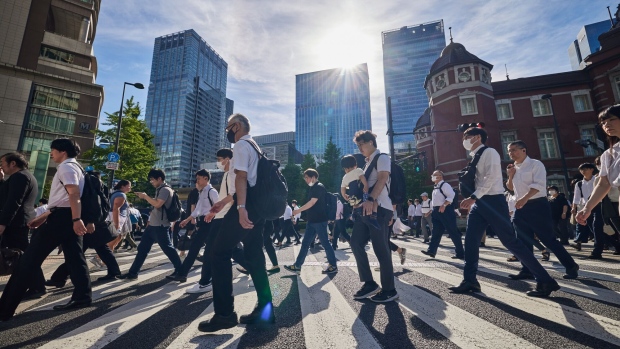 Morning commuters cross a street outside Tokyo Station in Tokyo, Japan, on Monday, Aug. 21, 2023. Japan's ministry of internal affairs will release the country's monthly unemployment rate on Aug. 29. Photographer: Shoko Takayasu/Bloomberg