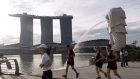 People exercise by the Merlion Park and Marina Bay Sands in Singapore, on Saturday, Oct. 8, 2022. Singapore is scheduled to announce its third quarter advanced gross domestic product (GDP) estimate on Oct 10, 2022. Photographer: Ore Huiying/Bloomberg