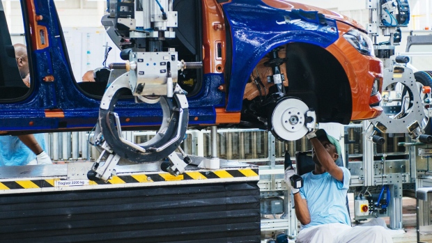 A worker adjusts the wheel unit of a VW Polo automobile on the production line at the Volkswagen AG plant in Uitenhage, South Africa, on Thursday, Jan. 25, 2018. Growth in European car sales will slow after reaching a 10-year high last year, an industry group said, as consumer worries about Brexit and future regulations on auto emissions curtail purchases. Photographer: Waldo Swiegers/Bloomberg