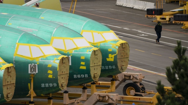 A worker walks near Boeing 737 fuselages outside the Boeing Co. manufacturing facility in Renton, Washington, US, on Monday, Feb. 5, 2024. Boeing Co. found more mistakes with holes drilled in the fuselage of its 737 Max jet, a setback that could further slow deliveries on a critical program already restricted by regulators over quality lapses. Photographer: David Ryder/Bloomberg