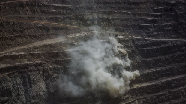 A plume of smoke rises at the Codelco Chuquicamata open pit copper mine near Calama, Chile, on Thursday, Aug. 2, 2018. Protests at the Chuquicamata copper mine in late July were the first labor disruptions in Chile this year, and happened amid calls for a strike from the union at the world's largest mine, BHP Billiton Ltd.'s Escondida. Photographer: Cristobal Olivares/Bloomberg