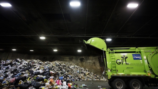 A GFL Environmental Inc. garbage truck drops off a load of waste at a transfer station in Toronto, Ontario, Canada, on Thursday, Oct. 24, 2019. GFL, North America's fourth-largest waste hauler by revenue, seeks to raise as much as $2.1 billion in what would be the largest initial public offering in Canada since 2004.
